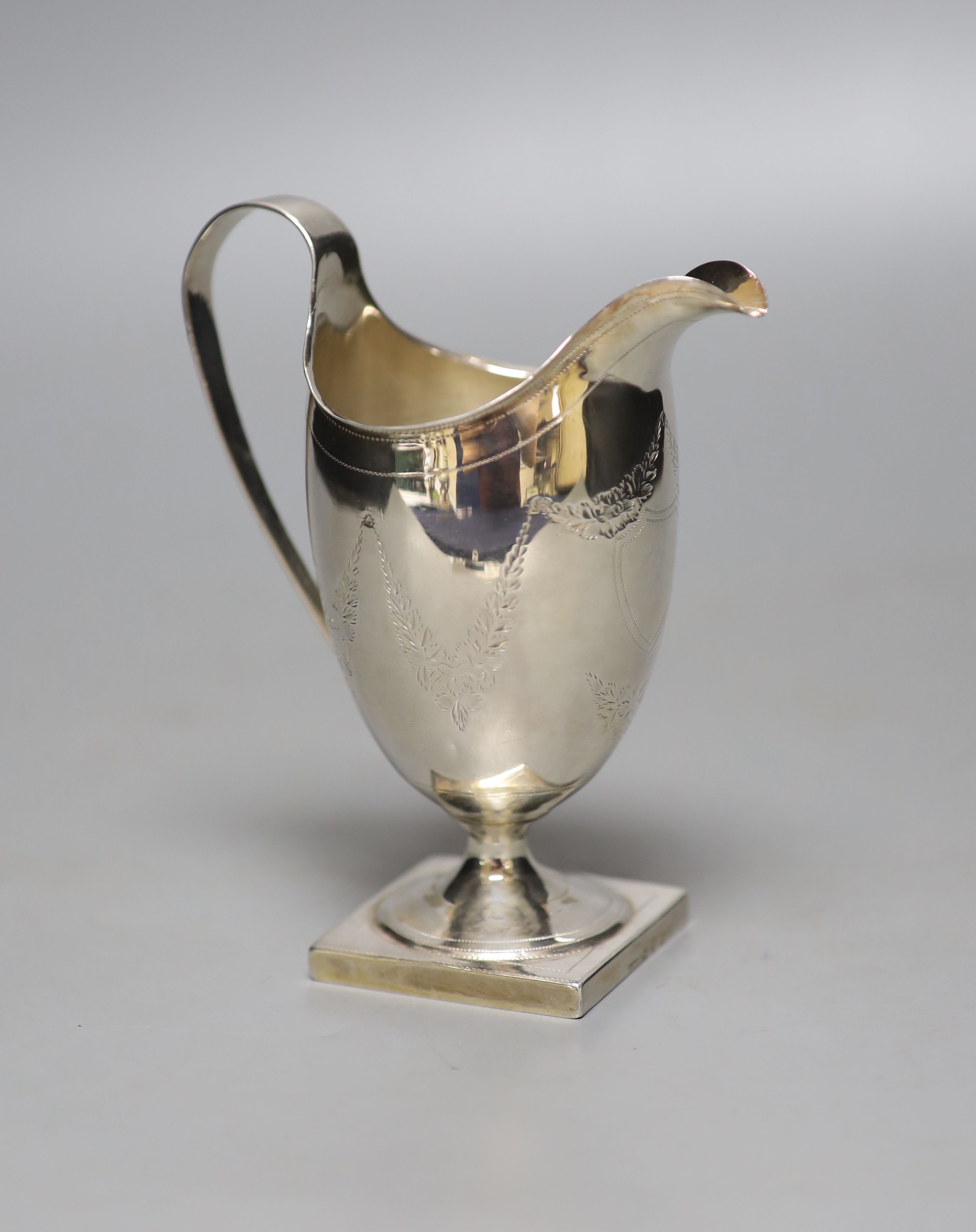 A George III engraved silver helmet shaped cream jug, Andrew Fogelburg, London, 1796, (a.f.), 13.5cm, 120 grams.